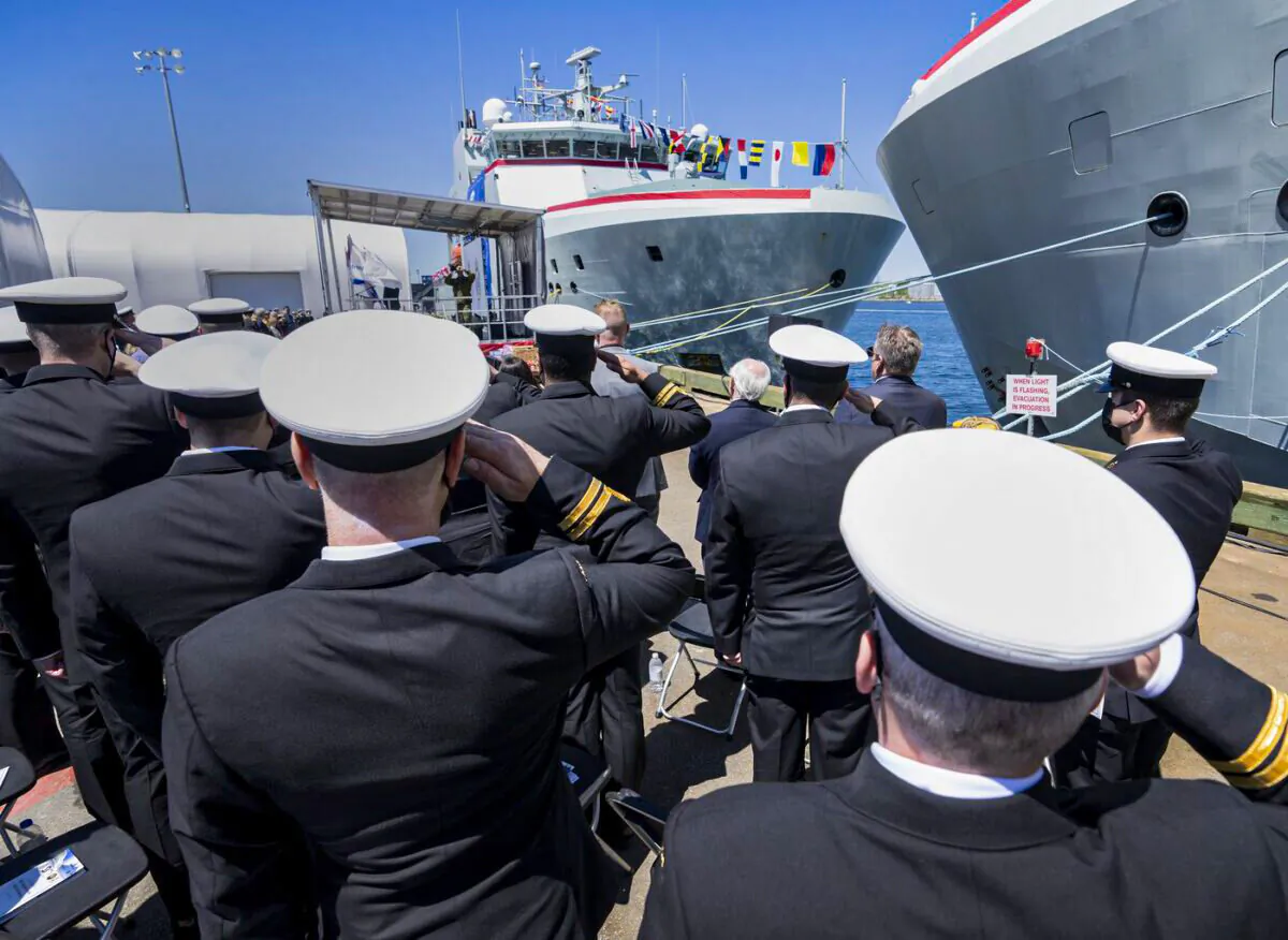Members of the Royal Canadian Navy salute during a naming ceremony for Arctic and offshore patrol ships, at Halifax Shipyards in Halifax on May 29, 2022. (The Canadian Press/Andrew Vaughan)