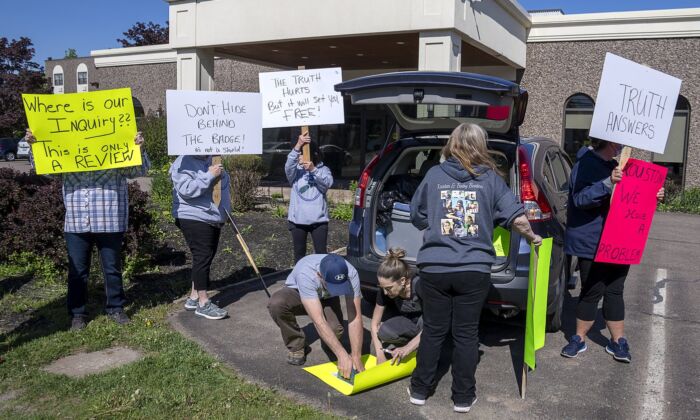 Family and friends of the victims protest outside the hotel where the Mass Casualty Commission inquiry into the April 2020 mass murders in rural Nova Scotia, is being held in Truro, N.S. on May 26, 2022. (The Canadian Press/Andrew Vaughan)