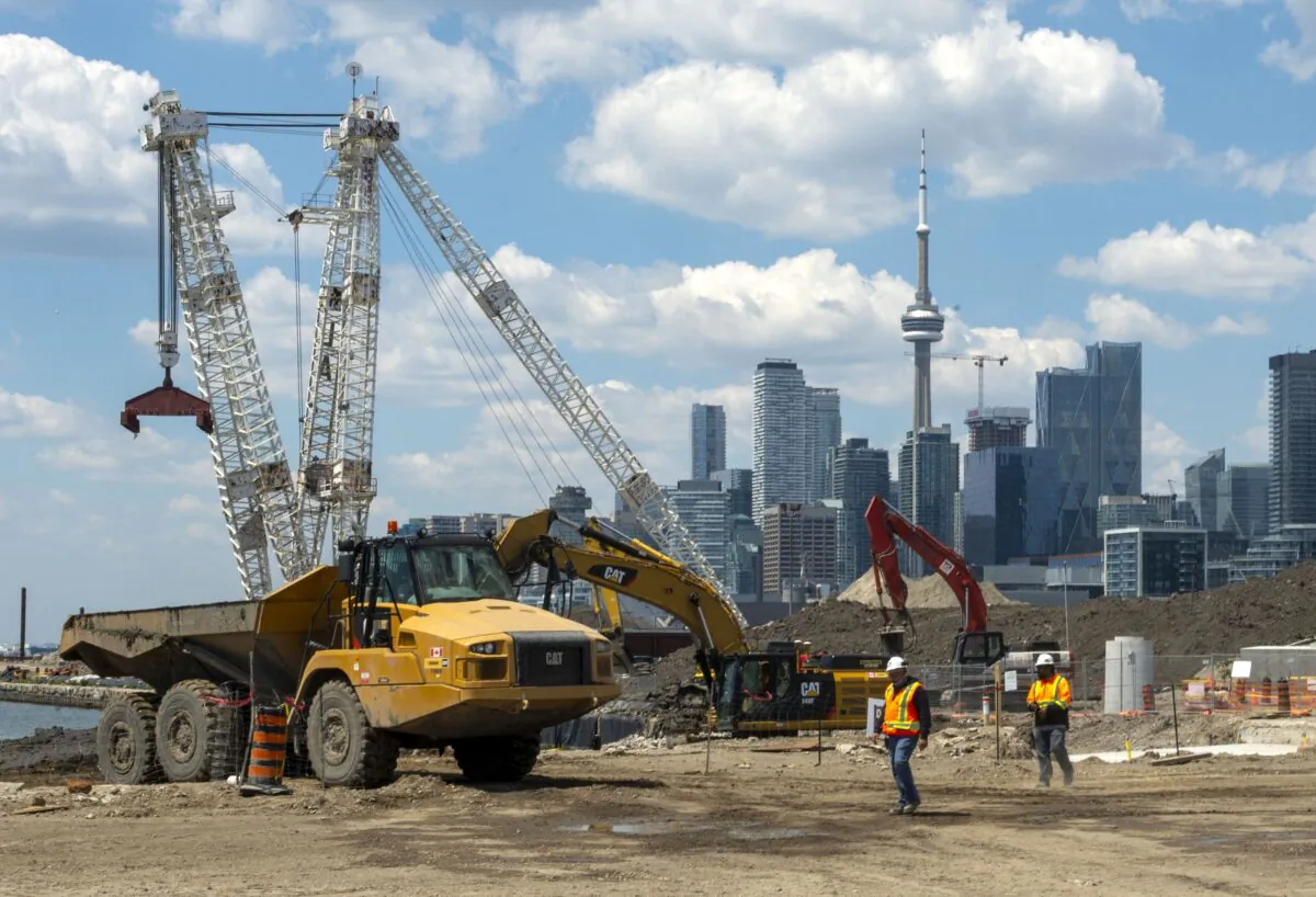 Construction crews work on the Port Lands renewal project in Toronto on June 1, 2021. (The Canadian Press/Frank Gunn)