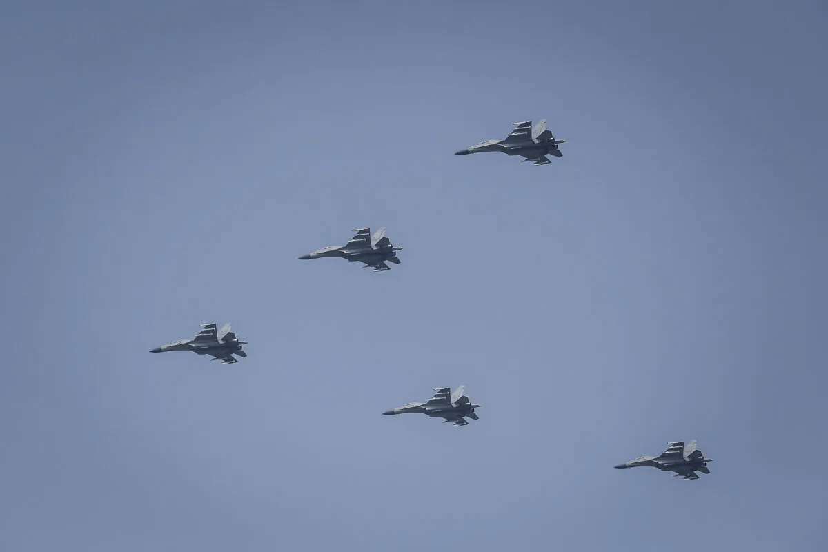 Planes from the Chinese People's Liberation Army (PLA) air force fly in formation in Beijing on Oct. 1, 2019. (Wang He/Getty Images)