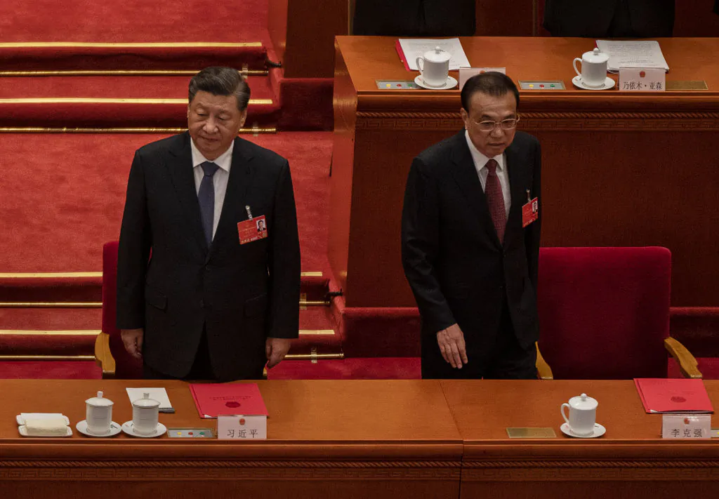 Chinese leader Xi Jinping (L) and Premier Li Keqiang arrive for the closing session of the National People's Congress at the Great Hall of the People in Beijing on March 11, 2022. (Kevin Frayer/Getty Images)