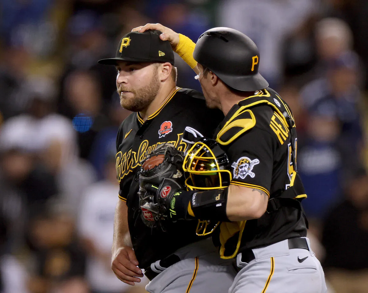 David Bednar #51 of the Pittsburgh Pirates celebrates a save with Michael Perez #5 and a 6-5 win over the Los Angeles Dodgers during the ninth inning at Dodger Stadium, in Los Angeles, on May 30, 2022. (Harry How/Getty Images)
