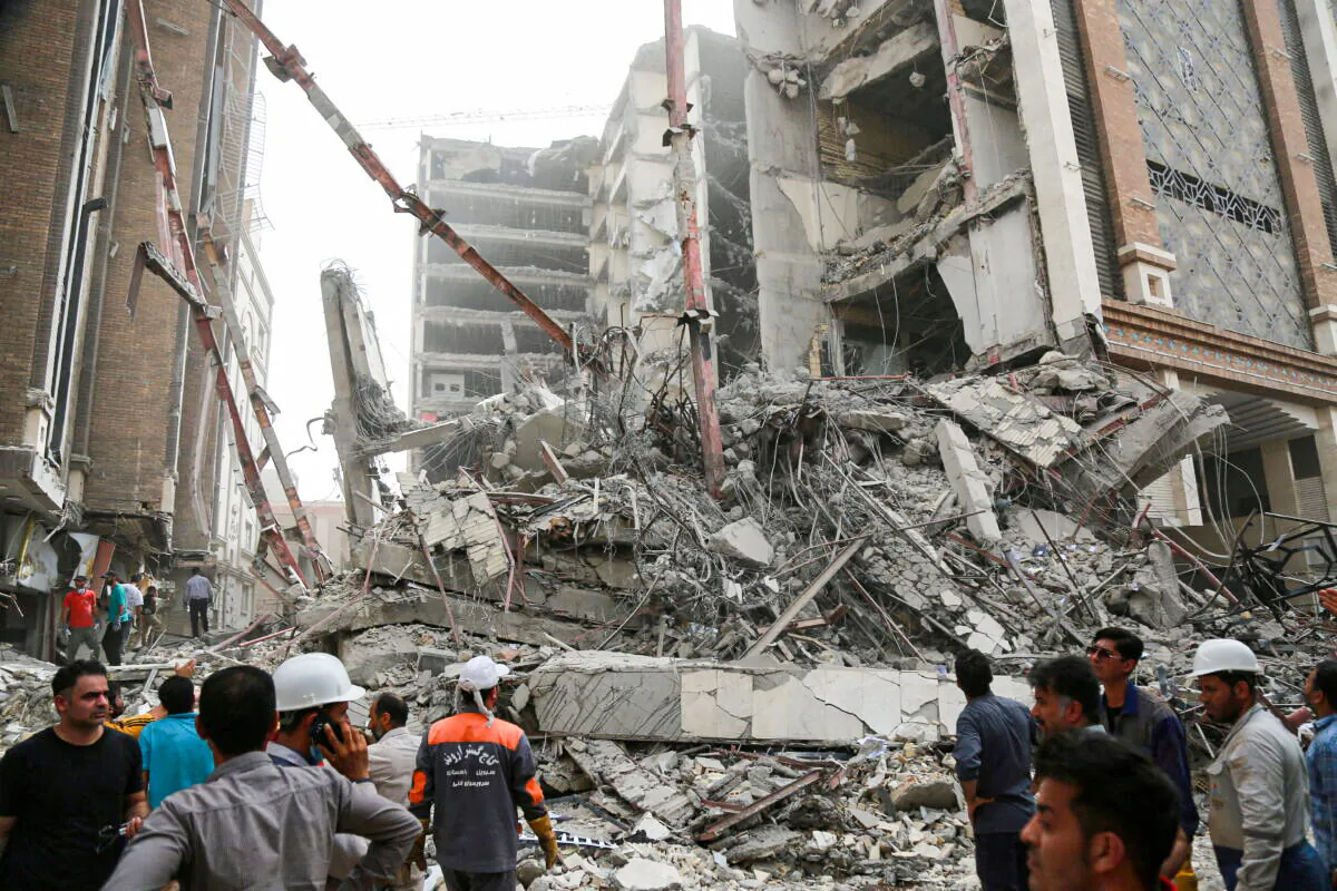 Rescue crews work at the site of a ten-story building collapse in Abadan, Iran, on May 23, 2022. (WANA via Reuters)