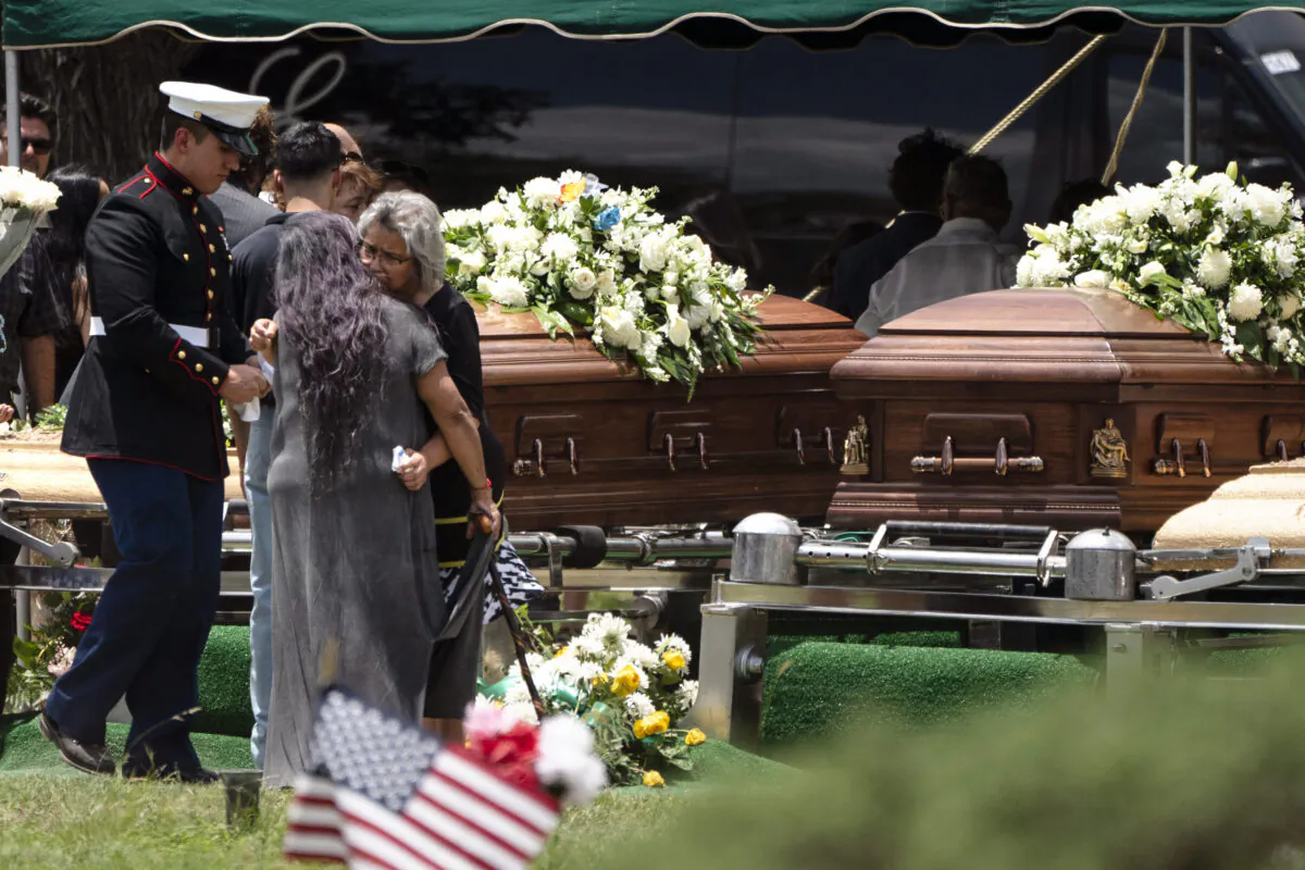 Two women comfort each other during the burial service for Irma Garcia and her husband Joe Garcia at Hillcrest Cemetery in Uvalde, Tex., on June 1, 2022. (Jae C. Hong/AP Photo)
