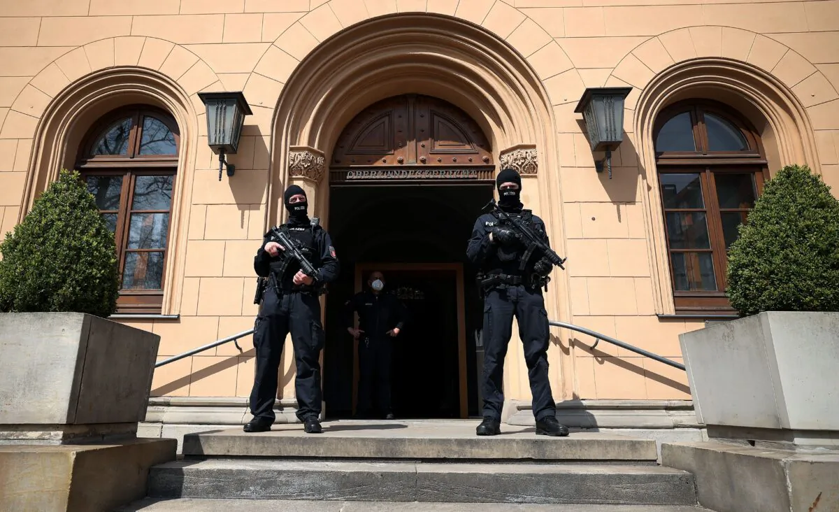 Policemen secure the entrance to the court building where the trial against Gambian defendant Bai L., accused of of crimes against humanity, murder and attempted murder, is taking place in Celle, northern Germany, on April 25, 2022. (Ronny Hartmann/AFP via Getty Images)