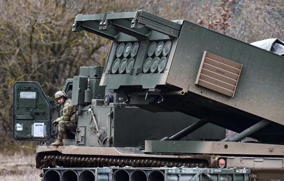 A U.S. soldier sits at a Multiple Launch Rocket System (MLRS) during the demonstration of the reload procedures after an artillery live fire event at a military training area in Grafenwoehr, southern Germany, on March 4, 2020. (Christof Stache/AFP via Getty Images)