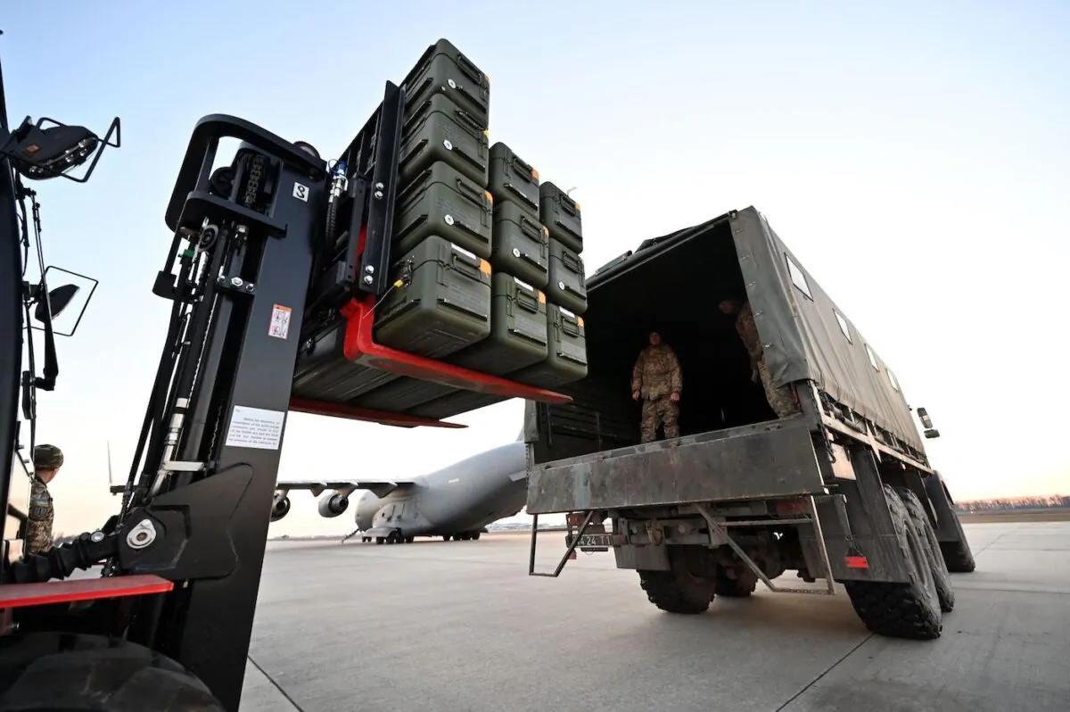 Servicemen of Ukrainian Military Forces move U.S.-made FIM-92 Stinger missiles and the other military assistance shipped from Lithuania to Boryspil Airport in Kyiv on Feb. 13, 2022. (Sergei Supinsky/AFP via Getty Images)