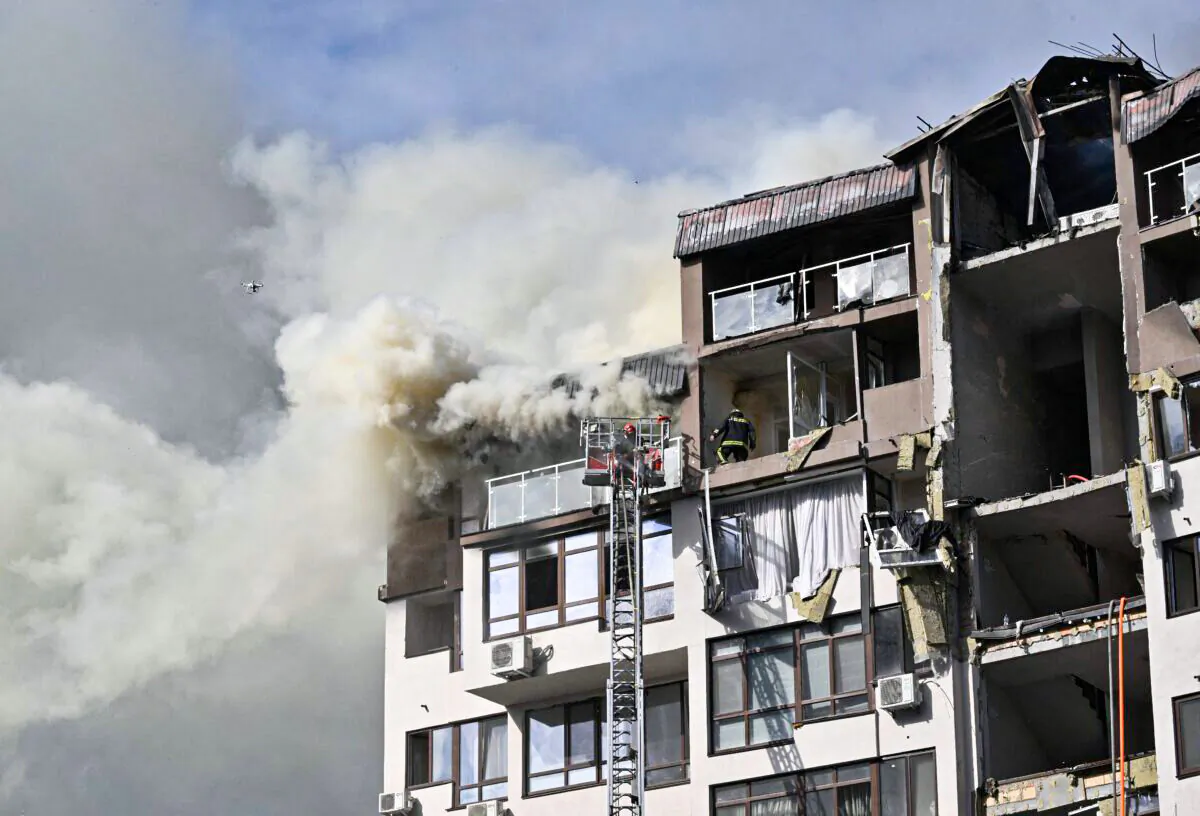 Rescuers and firefighters work in a damaged residential building, hit by Russian missiles in Kyiv on June 26, 2022, amid Russian invasion of Ukraine. (Genya Savilov/AFP via Getty Images)