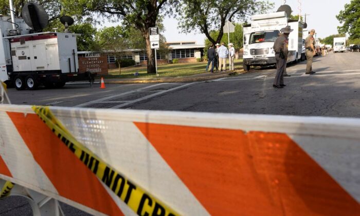 Law enforcement personnel investigate the scene at Robb Elementary School, the site of a mass shooting in Uvalde, Texas, U.S. May 25, 2022. (Nuri Vallbona/Reuters)