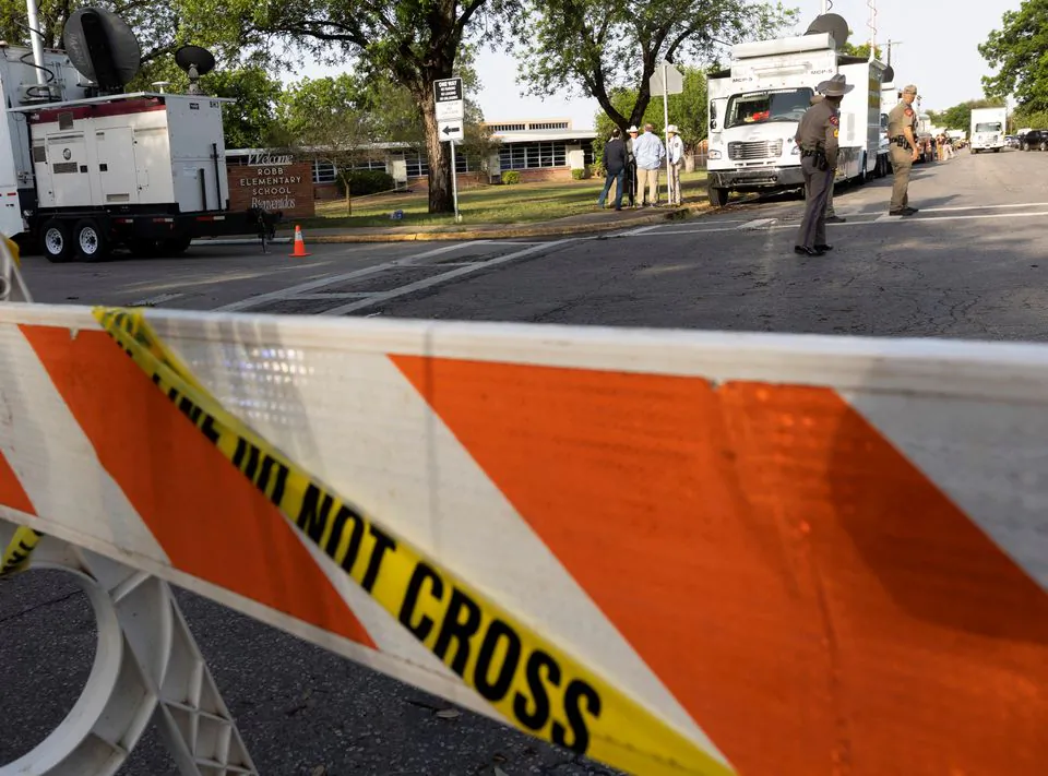 Law enforcement personnel investigate the scene at Robb Elementary School, the site of a mass shooting in Uvalde, Texas, U.S. May 25, 2022. (Nuri Vallbona/Reuters)