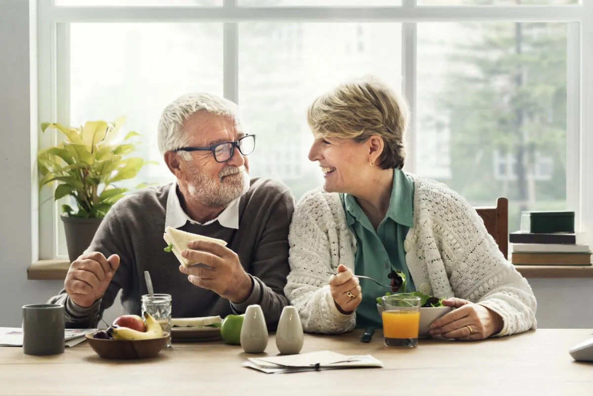 Happy old couple are eating their breakfast at home. (Rawpixel.com/ShutterStock)
