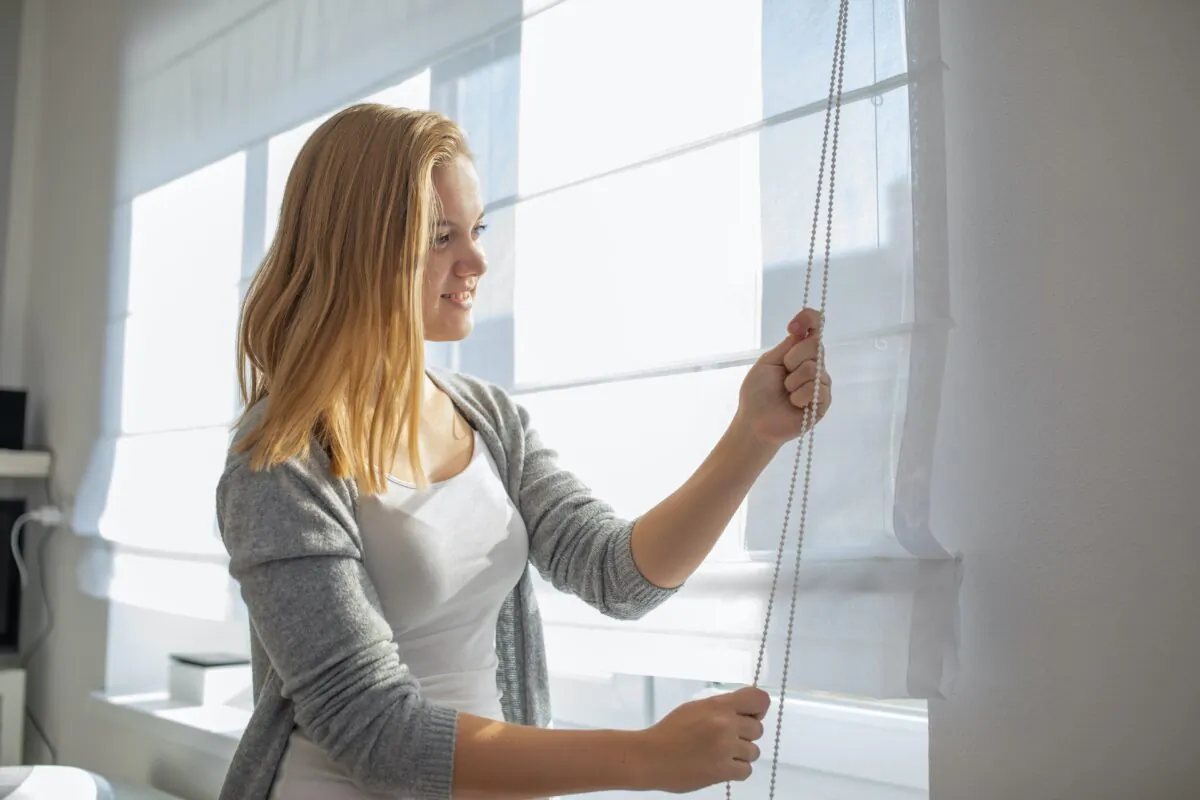 Passive solutions, like closing curtains or blinds, can go a long way in keeping your house cool in the summer. (l i g h t p o e t/Shutterstock)