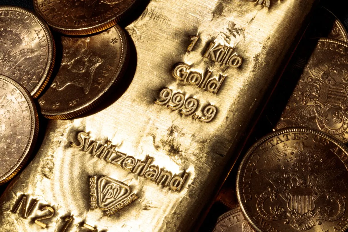 A one-kilo Swiss gold bar and U.S. dollar gold coins are pictured in Paris on Feb. 20, 2020. (Joel Saget/AFP via Getty Images)