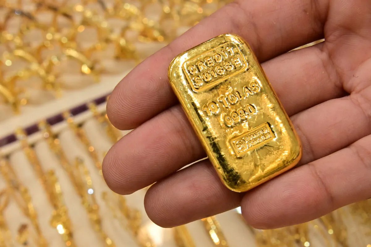 A merchant displays a gold bar at his shop in Dubai Gold Souk in the Gulf emirate on July 29, 2020. (Giuseppe Cacace/AFP via Getty Images)