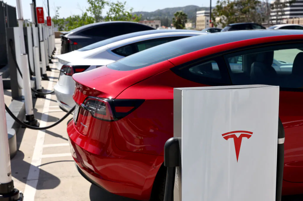 Tesla cars recharge at a Tesla Supercharger station in Pasadena, Calif., on April 14, 2022. (Mario Tama/Getty Images)