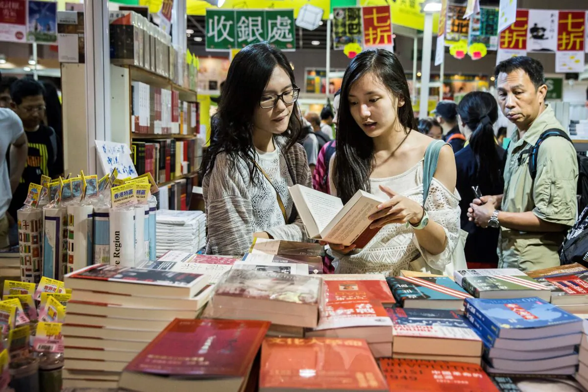 Visitors browse through books on display at the International Book Fair in Hong Kong on July 20, 2017. (Isaac Lawrence/AFP via Getty Images)