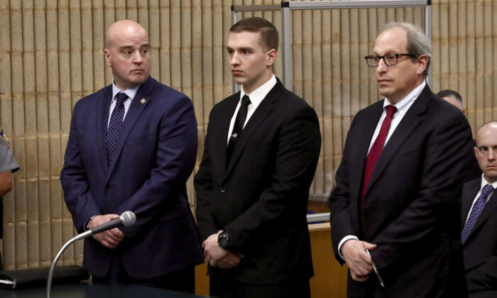 Connecticut State Trooper Brian North, (C), flanked by Andrew Matthews, president of the Connecticut State Police Union, (L), and attorney Jeffrey Ment, appears in Milford Superior Court, in Milford, Conn., on May 3, 2022. (Sean Fowler/Hartford Courant via AP)
