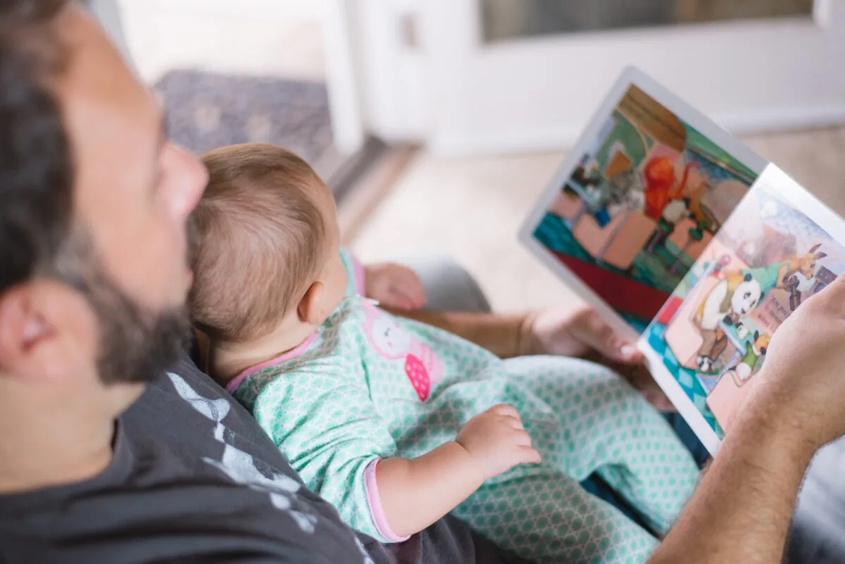A man reads a story book to a child.
(Picsea/Unsplash)