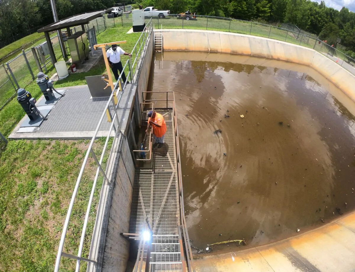 Orange County Public Works pump station manager Reginald Peoples clears a storm drainage grate of debris with foreman Lee Owens (L) at Bonnie Brook in Orlando, Fla., on June 2, 2022, as Central Florida readies for the possibility of heavy rainfall from the Gulf of Mexico this weekend following the remnants of Hurricane Agatha that hit southern Mexico on May 30, 2022. (Joe Burbank/Orlando Sentinel/TNS)