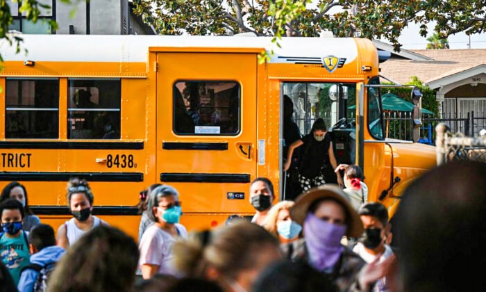 Students and parents arrive masked for the first day of the school year at Grant Elementary School in Los Angeles on Aug. 16, 2021. (Robyn Beck/AFP via Getty Images)