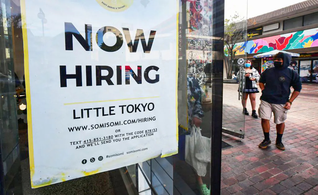 A 'Now Hiring' sign is posted in the window of an ice cream shop in Los Angeles, Calif., on Jan. 28, 2022. (Frederic J. Brown/AFP via Getty Images)