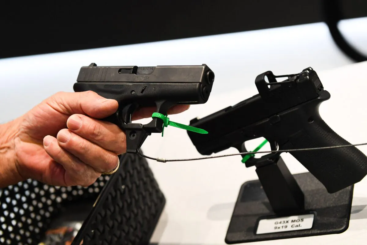 An attendee holds a Glock pistol during the National Rifle Association (NRA) annual meeting in Houston, Texas, on May 28, 2022. (Patrick T. Fallon/AFP/Getty Images)