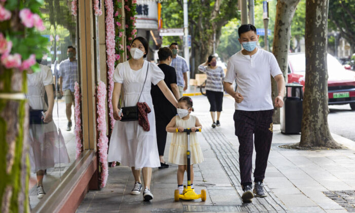 People walk in the street in Shanghai, China, after the lifting of lockdowns on June 2, 2022. (Hu Chengwei/Getty Images)
