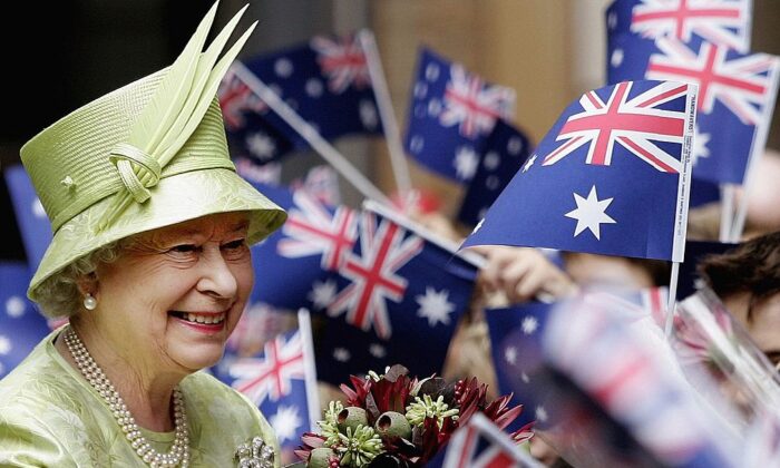 Queen Elizabeth ll smiles amongst Australian flags being waved by the crowd after the Commonwealth Day Service in Sydney, Australia, on March 13, 2006. (Rob Griffith-Pool/Getty Images)