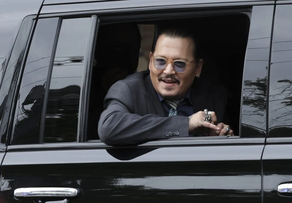 Actor Johnny Depp watches as supporters wave as he leaves the Fairfax County Courthouse, in Fairfax, Va., on May 25, 2022. (Kevin Dietsch/Getty Images)