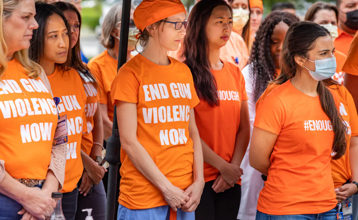 Nurses and doctors against gun violence stand together wearing orange at UCI Medical Center in Orange, Calif., on June 3, 2022. (John Fredricks/The Epoch Times)