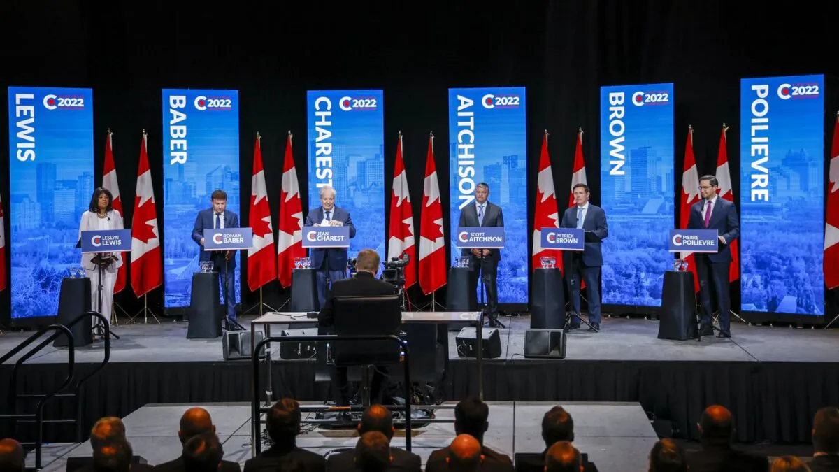 Candidates, left to right, Leslyn Lewis, Roman Baber, Jean Charest, Scott Aitchison, Patrick Brown, and Pierre Poilievre at the Conservative Party of Canada English leadership debate in Edmonton on May 11, 2022. (The Canadian Press/Jeff McIntosh)