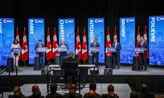 Candidates, left to right, Leslyn Lewis, Roman Baber, Jean Charest, Scott Aitchison, Patrick Brown, and Pierre Poilievre at the Conservative Party of Canada English leadership debate in Edmonton on May 11, 2022. (The Canadian Press/Jeff McIntosh)