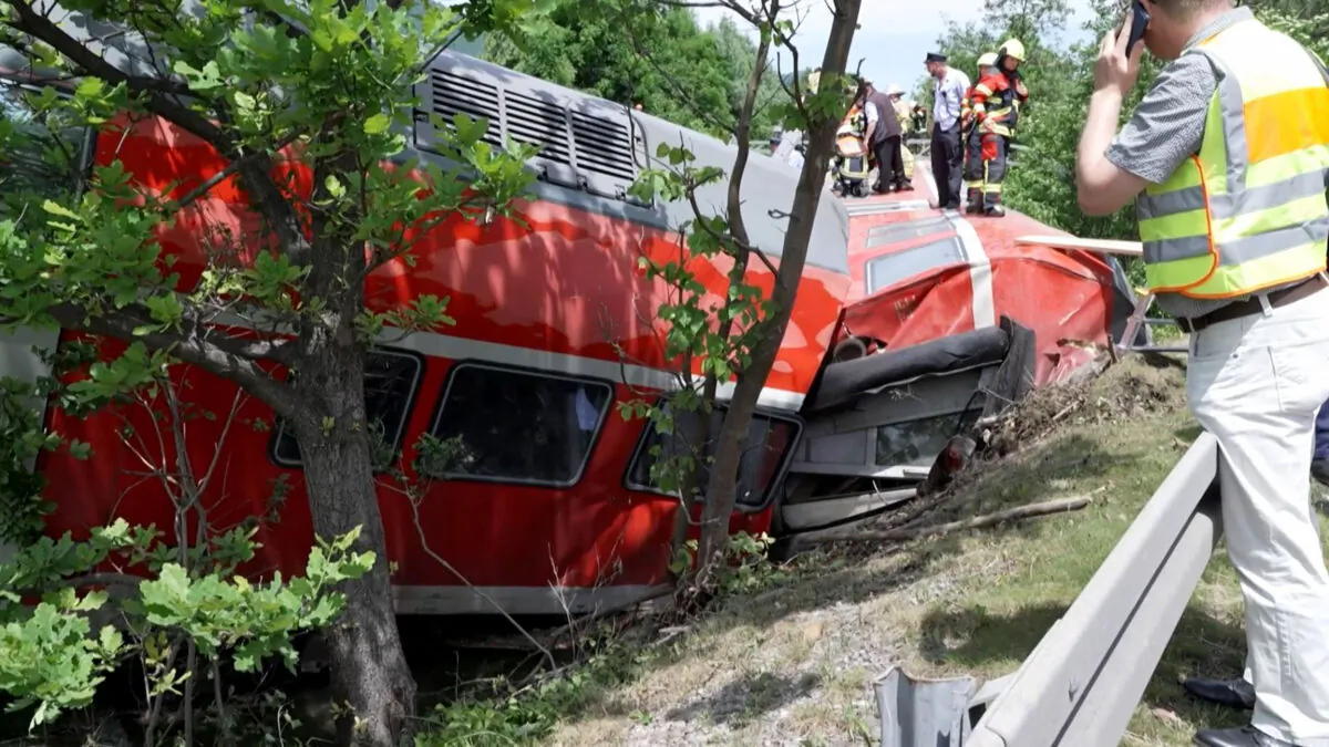 Firemen and rescue helpers working around a derailed train in Burgrain near Garmisch-Partenkirchen, southern Germany, on June 3, 2022. (STR/Network Pictures/AFP via Getty Images)