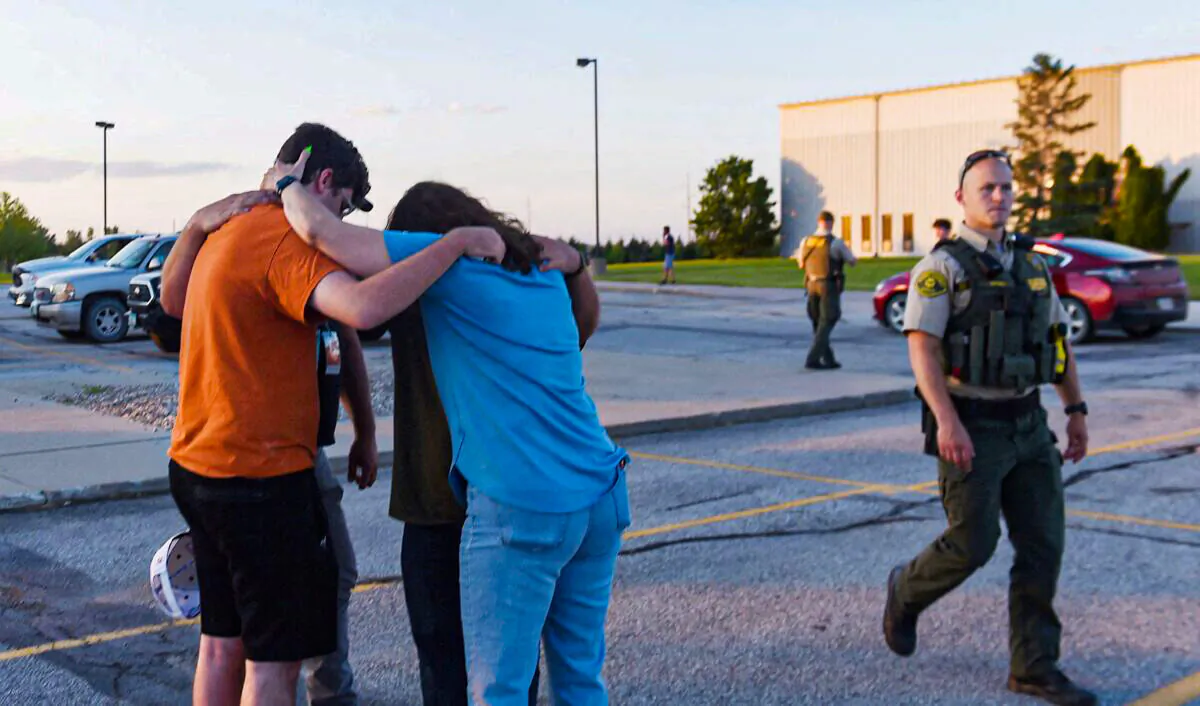 People pray at the CrossRoad Baptist Church parking lot after a shooting at Cornerstone Church in Ames, Iowa on June 2, 2022. (Nirmalendu Majumdar/USA Today Network via Reuters)