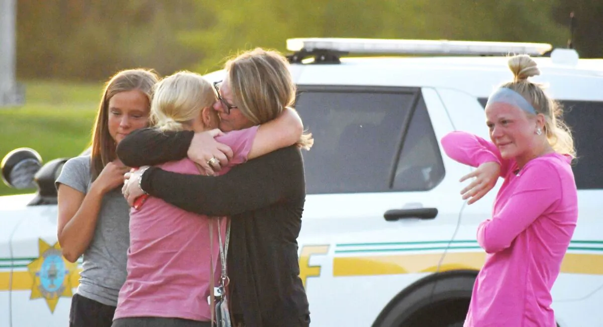 Survivors hug their family members and friends at the Cornerstone Baptist church parking lot after a shooting outside the church in Ames, Iowa, on June 2, 2022. (Nirmalendu Majumdar/USA Today Network via Reuters)