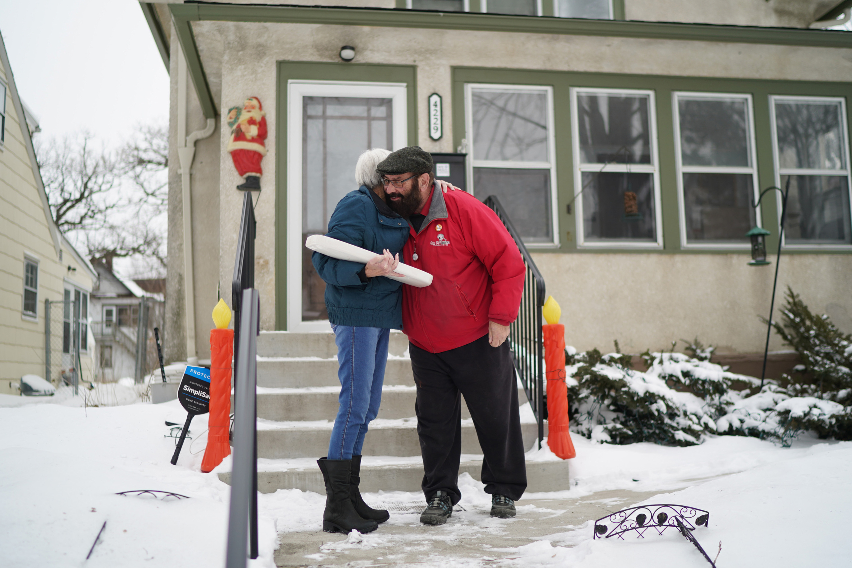 Homeowner Alan Peters turned over the signed toilet tank lid to plumber Otto Johnson's descendant, granddaughter Lynda Bornhoeft.