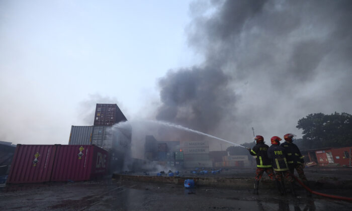 Firefighters work to contain a fire that broke out at the BM Inland Container Depot, a Dutch–Bangladesh joint venture, in Chittagong, 216 kilometers (134 miles) southeast of capital Dhaka in Bangladesh, on June 5, 2022. (AP Photo)