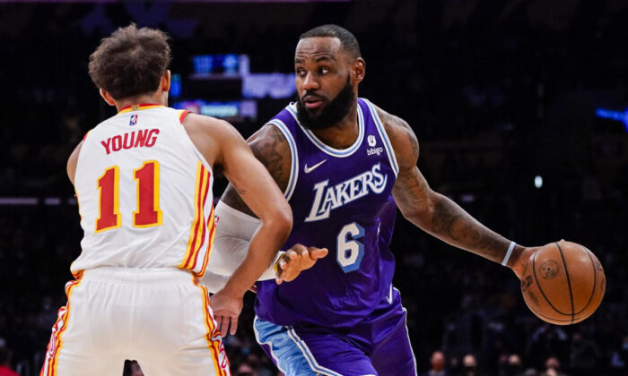 Atlanta Hawks guard Trae Young (11) defends against Los Angeles Lakers forward LeBron James (6) during the first half of an NBA basketball game in Los Angeles, Jan. 7, 2022. (Ashley Landis/AP Photo)