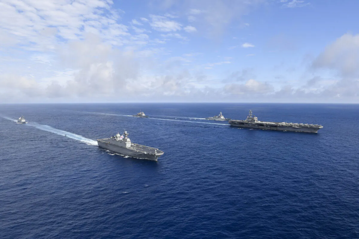 U.S. nuclear-powered aircraft carrier USS Ronald Reagan (R) and South Korea's landing platform helicopter (LPH) ship Marado (2nd L) sail during a joint military exercise at an undisclosed location on June 4, 2022. (South Korea Defense Ministry via AP)