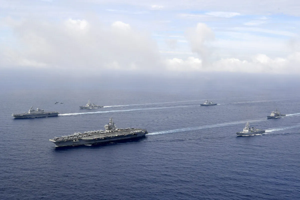 U.S. nuclear-powered aircraft carrier USS Ronald Reagan (2nd L) and South Korea's landing platform helicopter (LPH) ship Marado (L) sail during a joint military exercise at an undisclosed location on June 4, 2022. (South Korea Defense Ministry via AP)