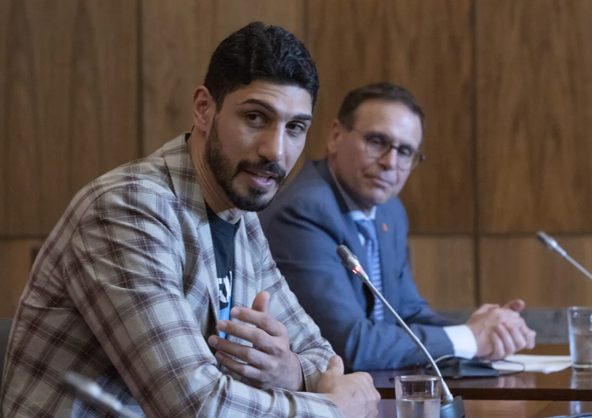 Basketball player and human rights defender Enes Kanter Freedom (L) takes part in news conference with Canadian Sen. Leo Housakos calling on the Canadian government to ban imports of goods made with forced labour in Xinjiang region of China, in Ottawa on June 6, 2022. (Fred Chartrand/The Canadian Press)