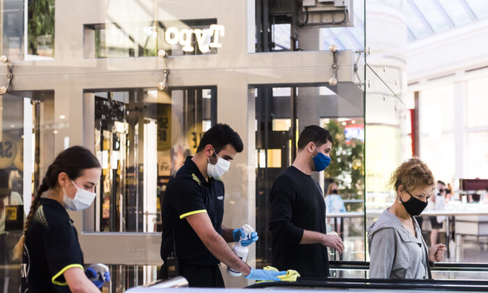 Employees maintain Covid-19 safety with frequent cleaning at Chadstone the Fashion Capital in Melbourne, Australia, on Dec. 26, 2020. (Naomi Rahim/Getty Images)