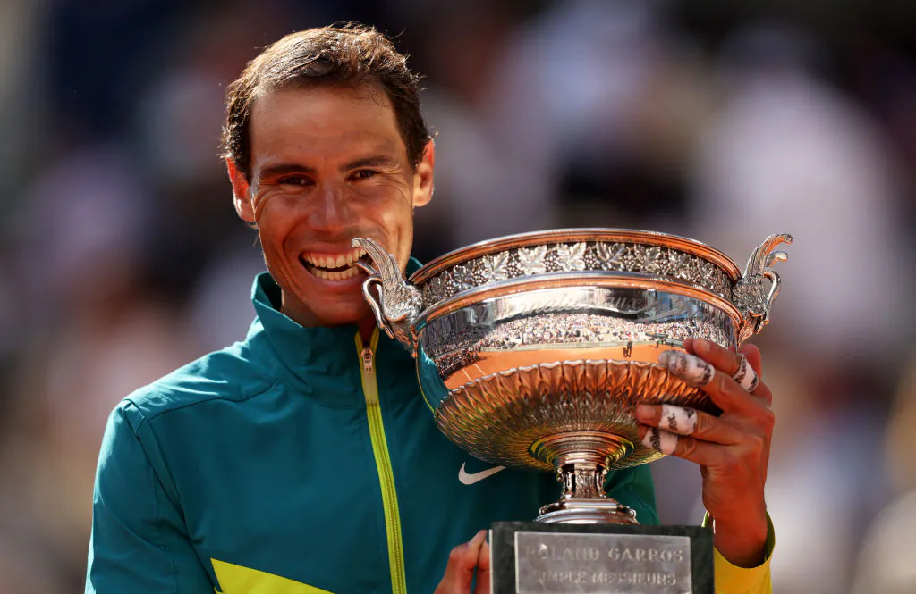 Rafael Nadal of Spain bites the trophy after winning against Casper Ruud of Norway during the Men's Singles Final match on Day 15 of The 2022 French Open at Roland Garros in Paris, France, on June 5, 2022. (Clive Brunskill/Getty Images)