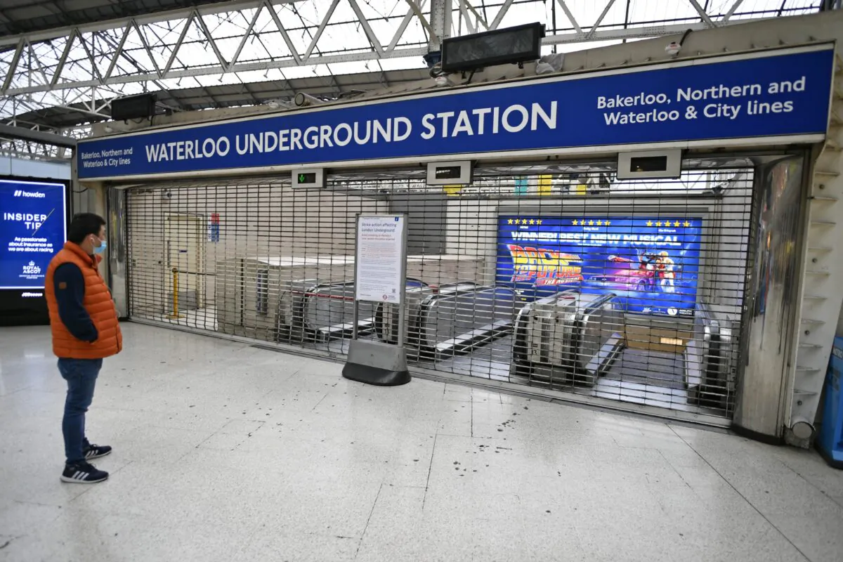 A commuter at Waterloo Station, as members of the Rail, Maritime, and Transport union take industrial action in a dispute over jobs and pensions, in London, on June 6, 2022. (PA Media)