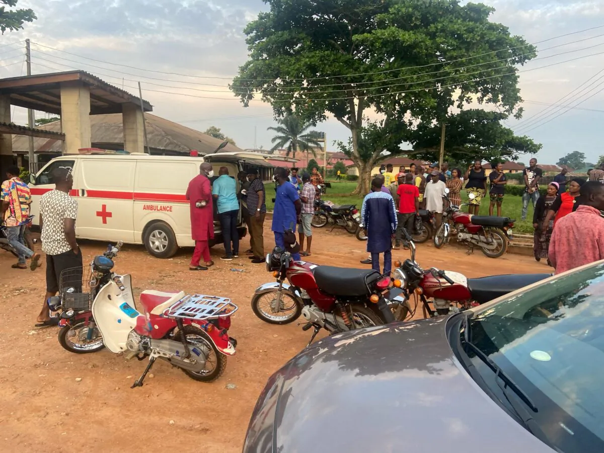 Relatives of churchgoers who were attacked by gunmen during Sunday's church service gather as health workers attend to victims brought in by ambulance after the attack at St. Francis Catholic Church, in Owo, Nigeria on June 5, 2022. (Stringer/Reuters)