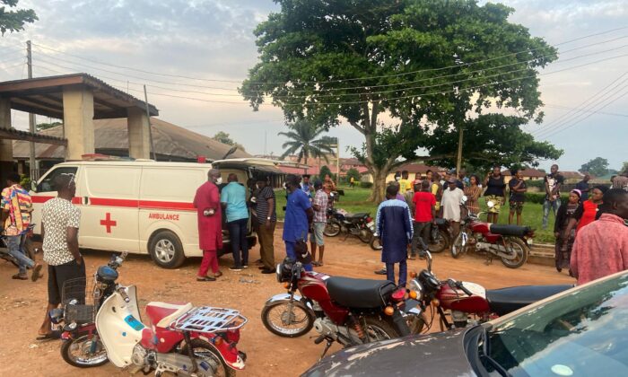 Relatives of churchgoers who were attacked by gunmen during Sunday's church service gather as health workers attend to victims brought in by ambulance after the attack at St. Francis Catholic Church, in Owo, Nigeria on June 5, 2022. (Stringer/Reuters)