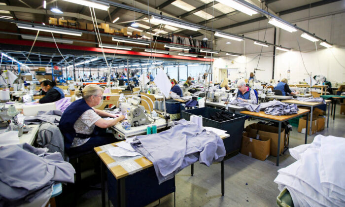 Tibard employees make uniforms for health workers at NHS at their factory in Dukinfield, Britain, on April 6, 2020. (Molly Darlington/Reuters)
