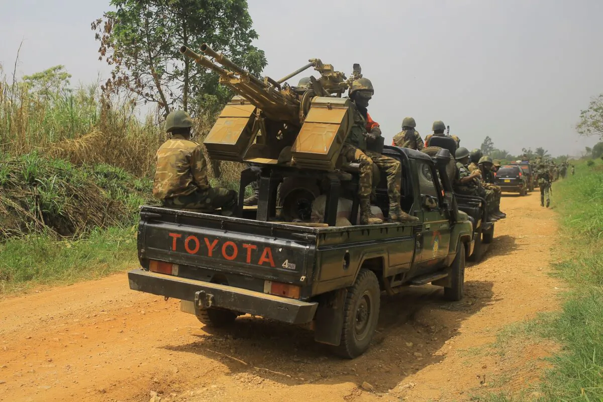 Vehicles of FARDC (Armed Forces of the Democratic Republic of Congo) soldiers escort civilian vehicles transporting goods from Beni towards Komanda on the national road number on March 19, 2022. (Sébastien Kitsa Musayi/AFP via Getty Images)