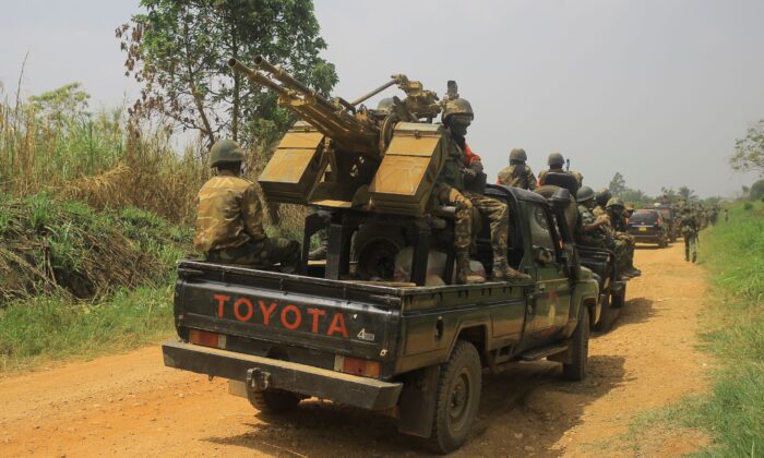 Vehicles of FARDC (Armed Forces of the Democratic Republic of Congo) soldiers escort civilian vehicles transporting goods from Beni towards Komanda on the national road number on March 19, 2022. (Sébastien Kitsa Musayi/AFP via Getty Images)