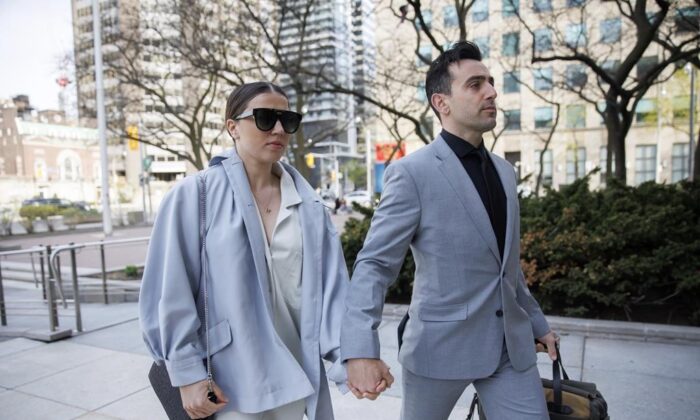 Canadian musician Jacob Hoggard arrives alongside his wife Rebekah Asselstine, for his sex assault trial at a court in Toronto on May 10, 2022. (The Canadian Press/Cole Burston)